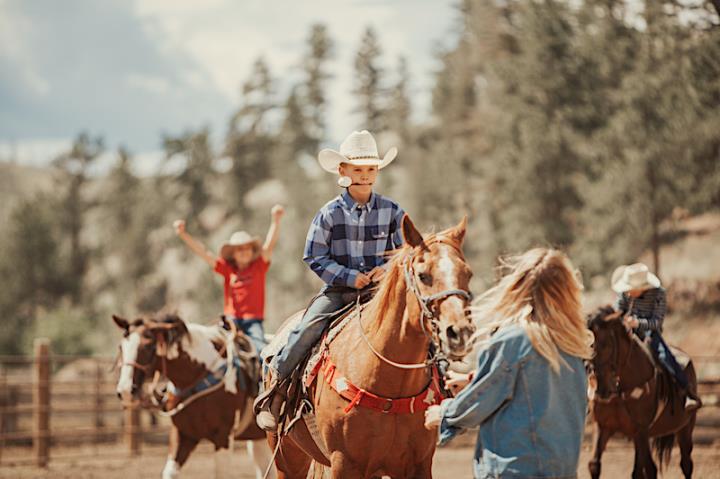 Child on horse doing egg and spoon race